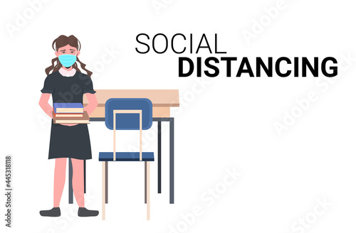schoolgirl wearing face mask to prevent coronavirus pandemic social distancing covid-19 quarantine