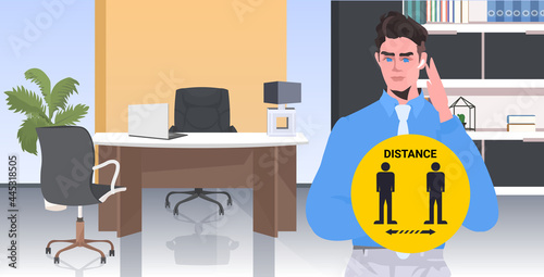 businessman holding round sign social distancing coronavirus epidemic protection self isolation concept