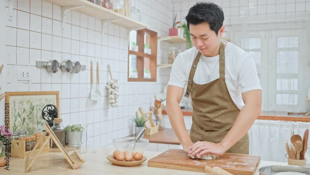 Asian attractive man stay home in kitchen and practice baking bakery. Asian attractive man stay home in kitchen and practice baking bakery.