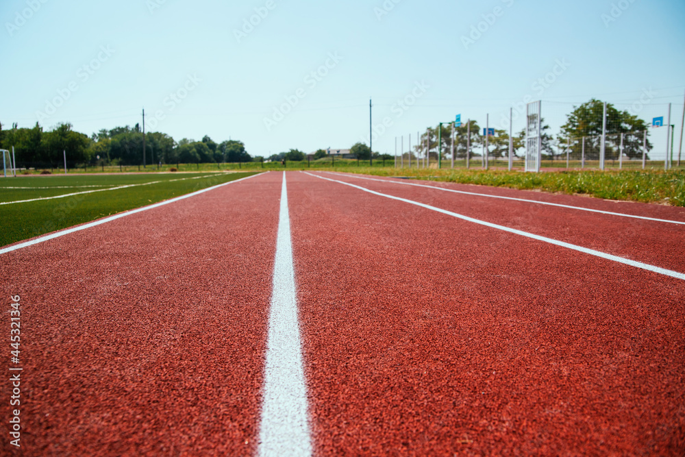 Covering the treadmill in close-up. Marked white lines on the sports field.
