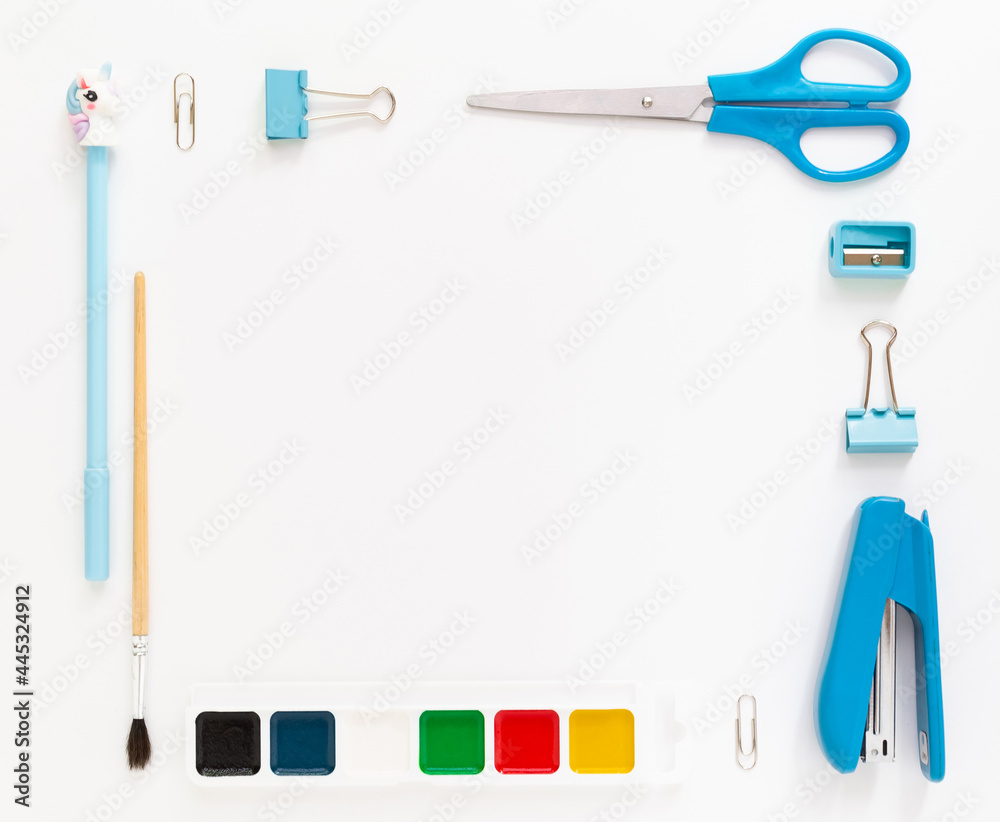 Top view of modern white blue office desktop with school supplies and stationery on table around empty space for text. Back to school concept flat lay with mockup Top view of modern white blue office desktop with school supplies and stationery on table around empty space for text. Back to school concept flat lay with mockup