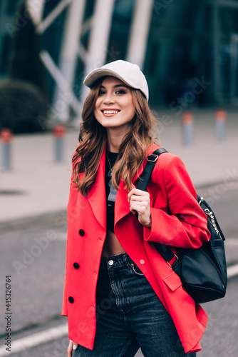 glamour woman in trendy outfit posing against the building urban background, fashion look. Outdoor fashion portrait of stylish young woman