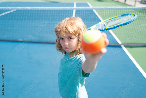Kid boy at the tennis competition. Child practicing tennis forehand. © Volodymyr