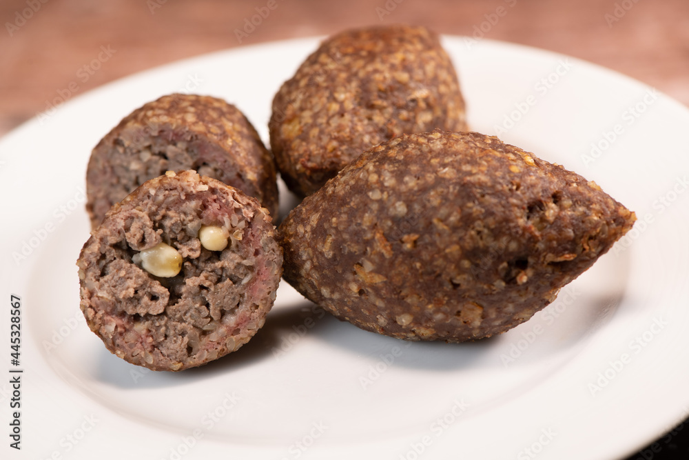 Traditional kebbe and pita bread on big round plate in lebanese restaurant. High quality photo Traditional kebbe and pita bread on big round plate in lebanese restaurant. High quality photo