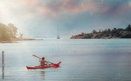 
Sportive woman canoeing in the sea photo