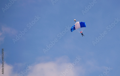 The parachutist soars in the air high in the clouds. Skydiving concept.