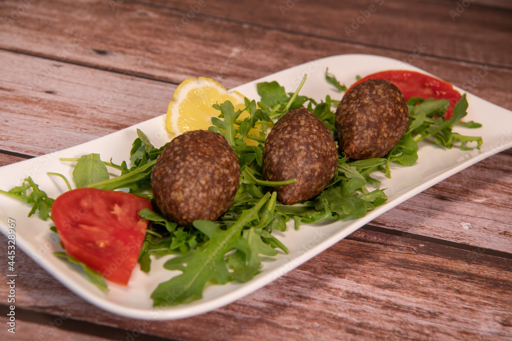 Traditional kebbe and pita bread on big round plate in lebanese restaurant. High quality photo Traditional kebbe and pita bread on big round plate in lebanese restaurant. High quality photo