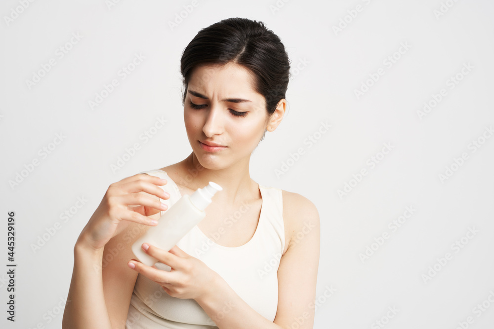woman in white t-shirt lotion in hands clean skin cosmetics woman in white t-shirt lotion in hands clean skin cosmetics