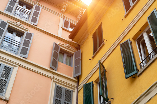 Vintage windows of old building in Europe. City architecture and details with sunlight background.