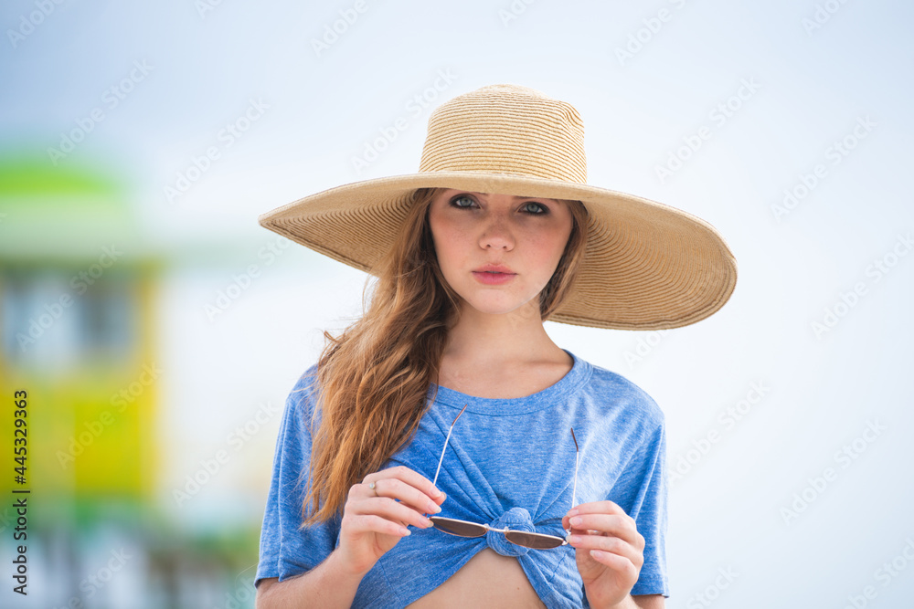 Summer woman with hat and sunglasses. Close up outdoor portrait.