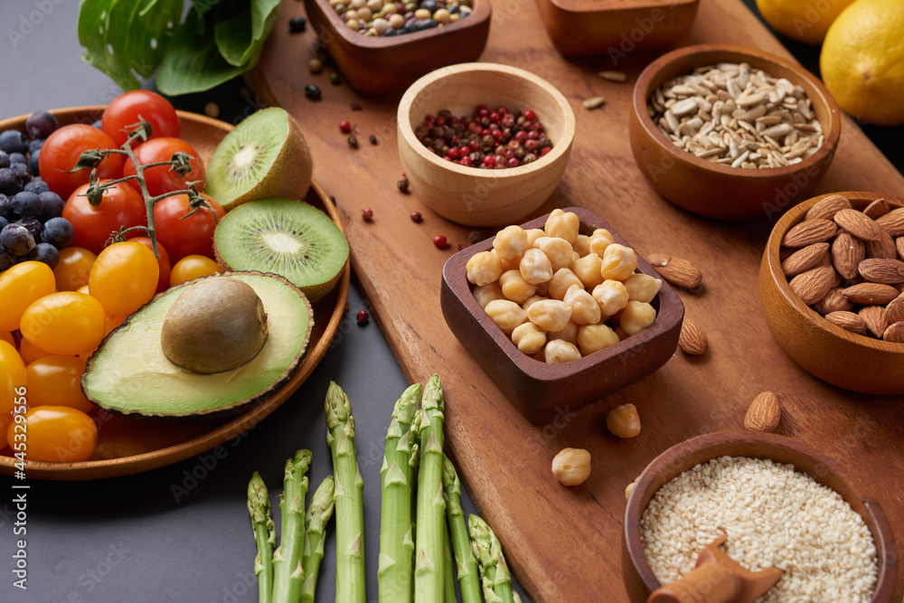 Different vegetables, seeds and fruits on table. Healthy diet..vegetarian, vegan food cooking ingredients. Flat-lay of vegetables, fruit, beans, cereals, kitchen utencil, dried flowers, top view.