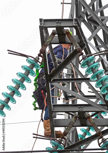 Electrician is working on a pole © michaklootwijk