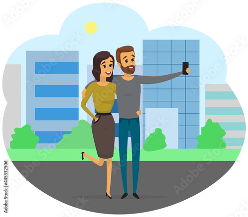 Young man and woman standing and making self portrait with mobile phone camera. Relationship and technology concept. Couple with phone is posing for joint photo. People take selfies together