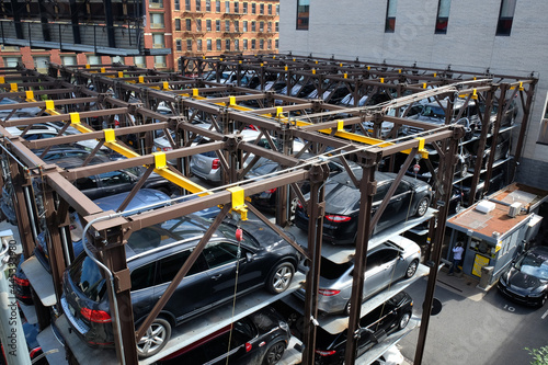 Фотография Innovative city parking system with Cars stacked in a multi-level parking lot in