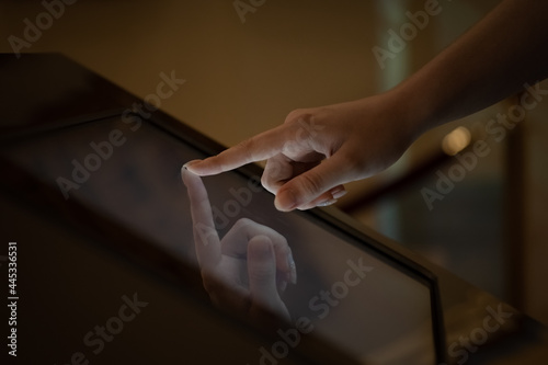 a person uses a touch screen, a finger presses a button on the monitor screen, modern technologies in study and life
