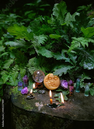 symbolic moon, candles, minerals, magic crystal ball in forest, natural background. meditation, relaxation, Witchcraft concept. healing gemstone. spiritual ritual for cleaning aura. wiccan witch altar © Ju_see