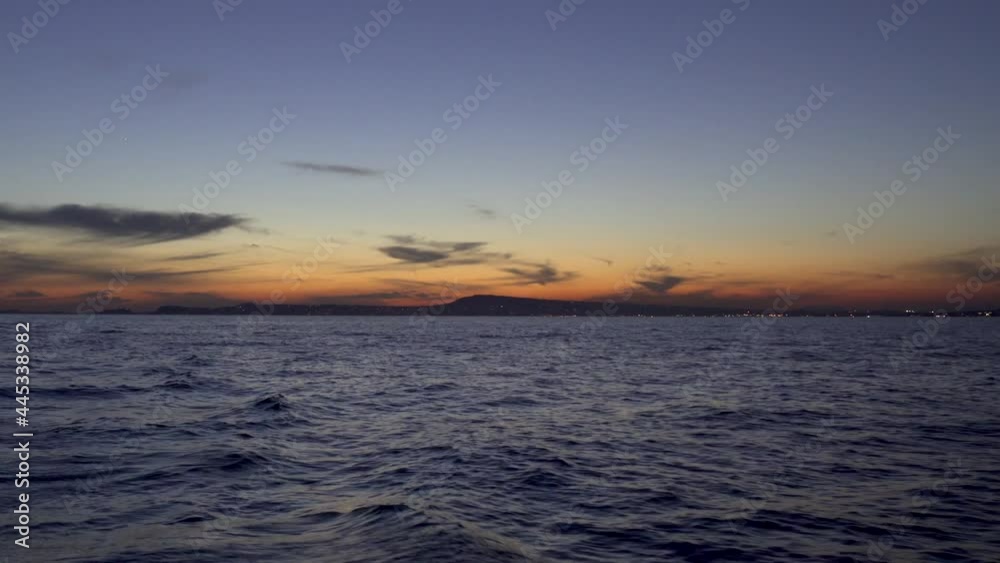 Romantic sunset as seen from a sailboat in the Tyrrhenian Sea by the Port of Naples, Italy Romantic sunset as seen from a sailboat in the Tyrrhenian Sea by the Port of Naples, Italy