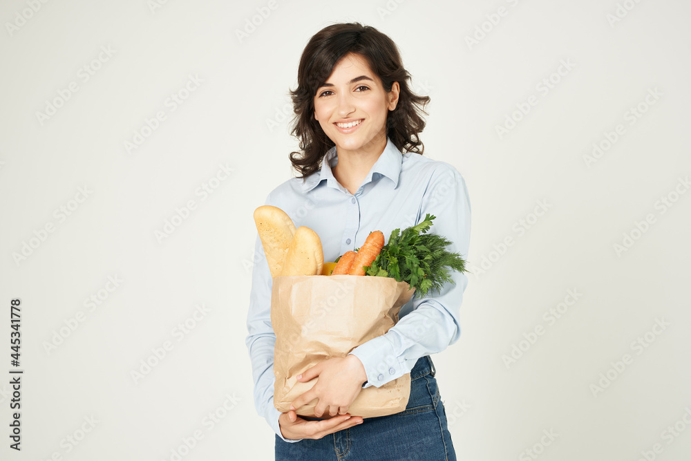 woman with a package of groceries housewife shopping in the supermarket woman with a package of groceries housewife shopping in the supermarket