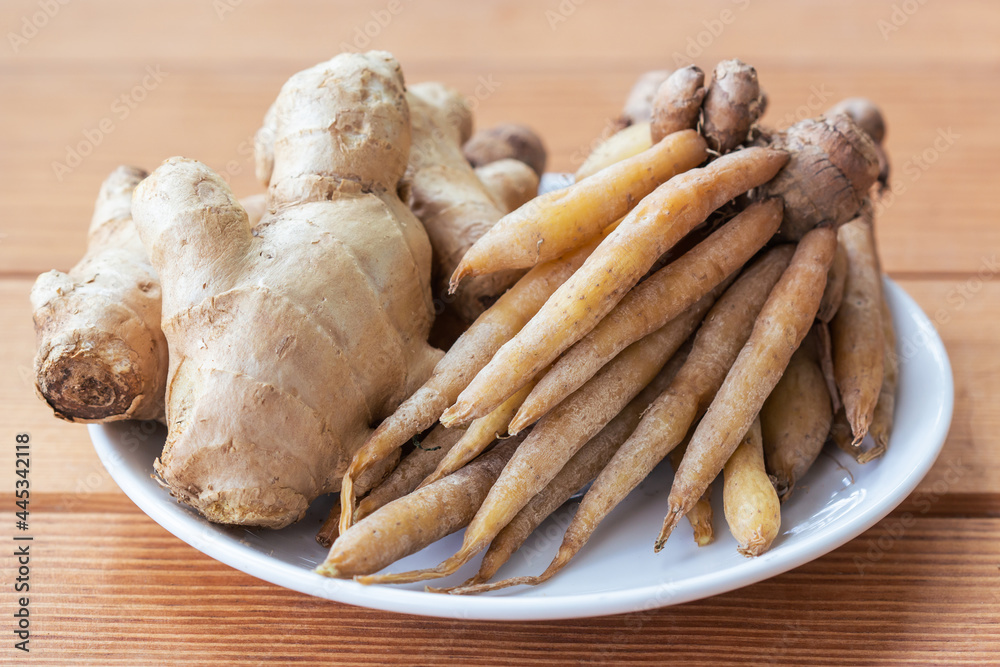 Kaempferia extract and fresh ginger on white plate. Kaempferia extract and fresh ginger on white plate.