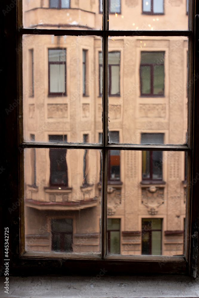 Old house through the window in SAINT-PETERSBUSR, Russia