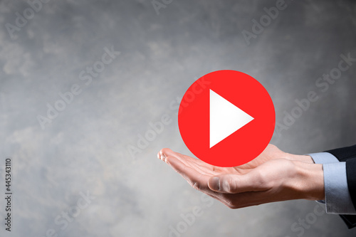 Businessman pressing, hold play button sign to start or initiate projects.Video Play Presentation. Idea for business, technology.media player button. Play icon.Go.