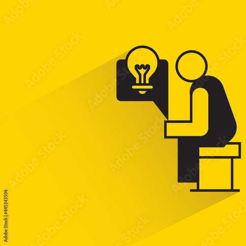 man sitting and thinking idea light bulb icon on yellow background