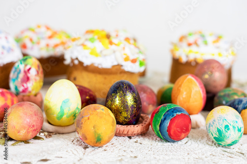 Easter cakes with Easter eggs on a vintage tablecloth, preparation for the holiday