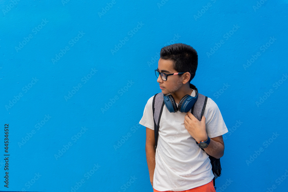Boy at school with his backpack and headphones. Boy at school with his backpack and headphones.