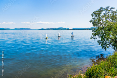 Sailing. A sailboat stands at the pier on the lake. photo
