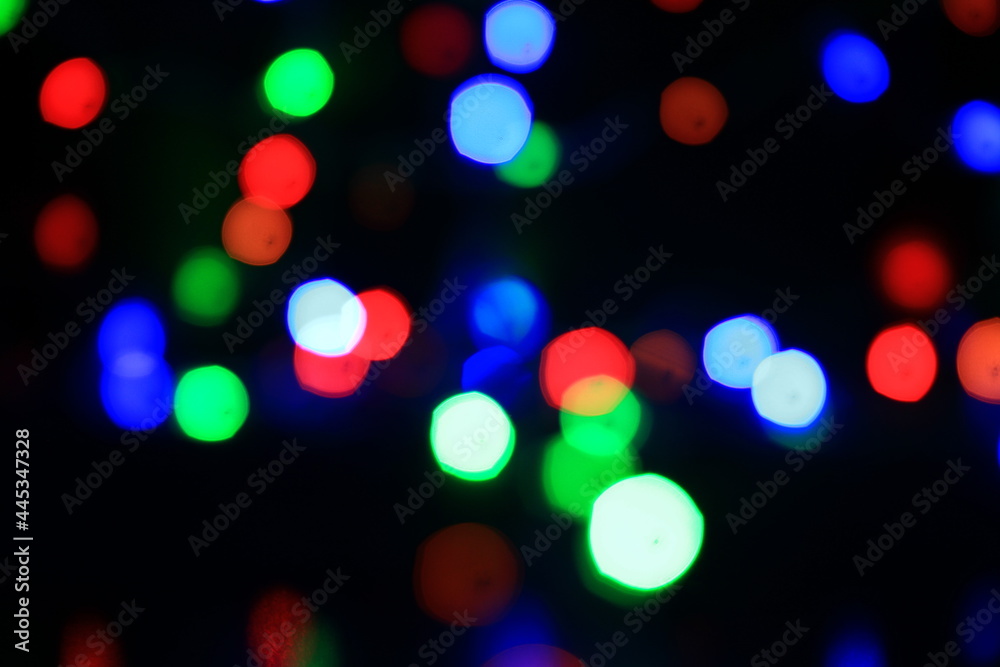 Fototapeta premium Abstract multi colored lights on a black background.