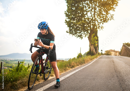 The cyclist looks at the mobile.sport, phone, bicycle