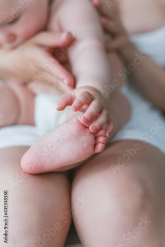 Close-up of baby's feet in mom's. Baby. Home. Cozy.