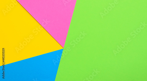 Multicolored paper geometric background. Colored paper pattern.