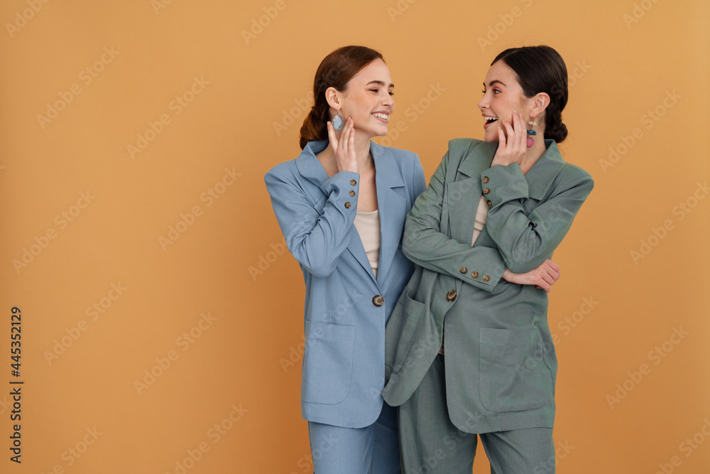 Two smiling elegant women wearing smart jackets Two smiling elegant women wearing smart jackets