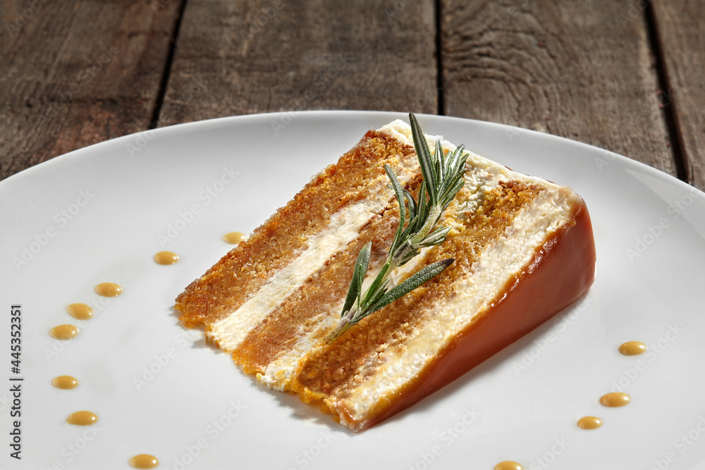 Slice of layered honey cake with sour cream and caramel sauce Slice of layered honey cake with sour cream and caramel sauce