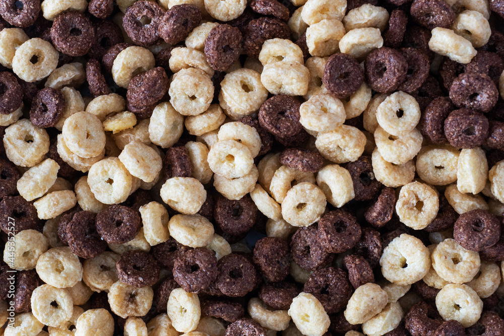 Background Dry breakfast cereals. Chocolate and corn rings made from natural cereals. Close up. Background Dry breakfast cereals. Chocolate and corn rings made from natural cereals. Close up.