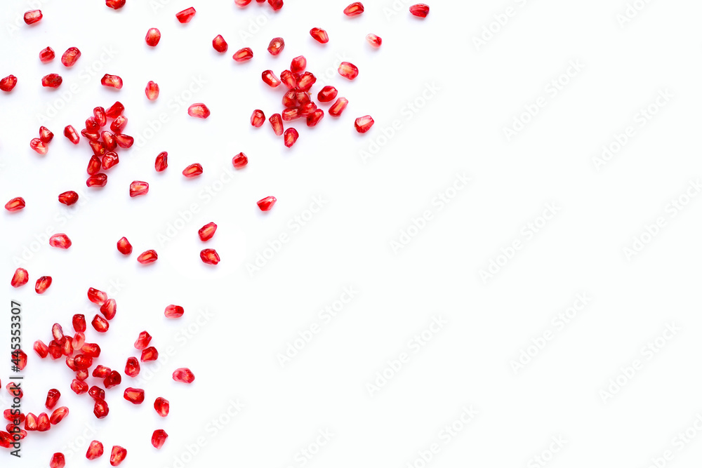 Pomegranate seeds on white background. Copy space