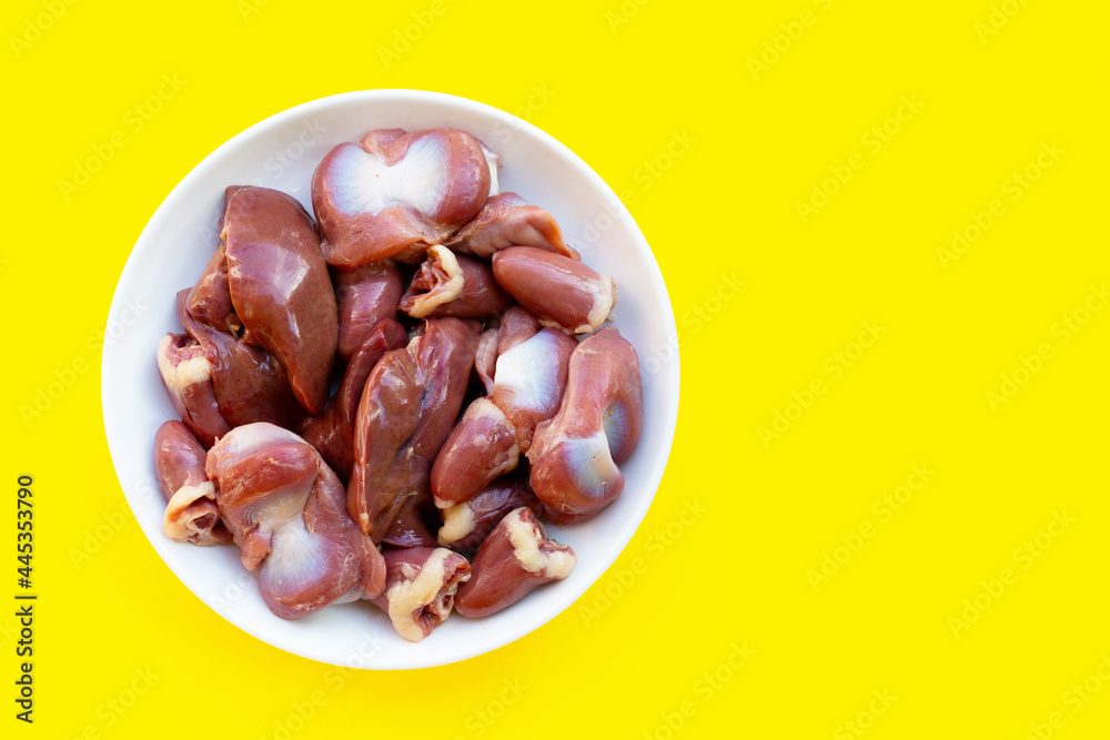 Mixed chicken entrails in white plate on yellow background. Mixed chicken entrails in white plate on yellow background.