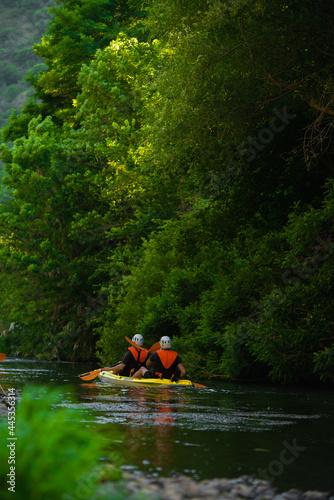 Two male friends kayaking together