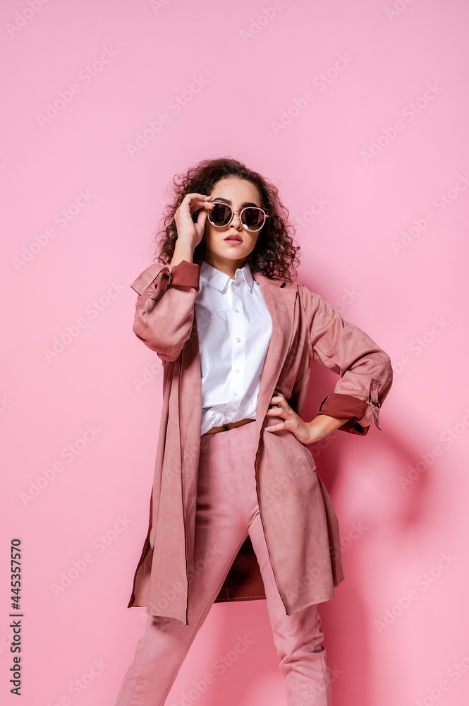 Young elegant woman in trendy pink coat. isolated studio shot