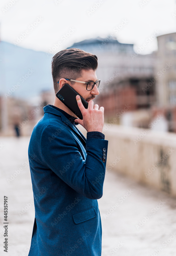Cheerful businessman talking on mobile phone Cheerful businessman talking on mobile phone