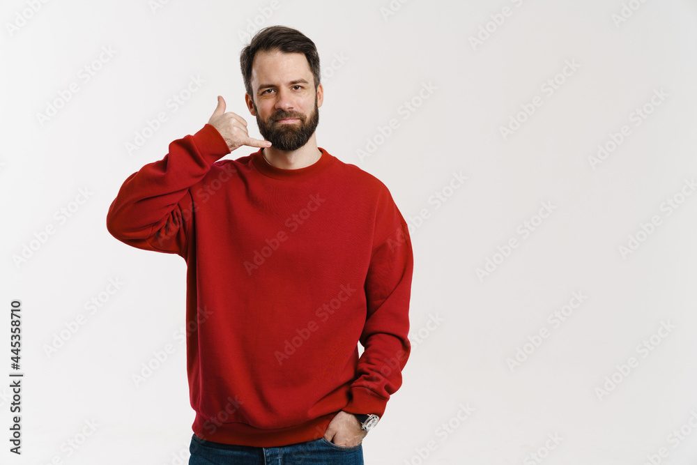 Brunette white man with beard showing handset gesture Brunette white man with beard showing handset gesture