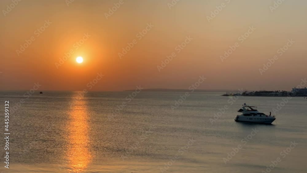 Sunset over the sea with boats. Time Lapse.