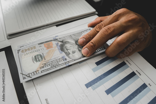 Man offering batch of hundred dollar bills. Hands close up. Venality, bribe, corruption concept. Hand giving money - United States Dollars (or USD). Hand receiving money from businessman.