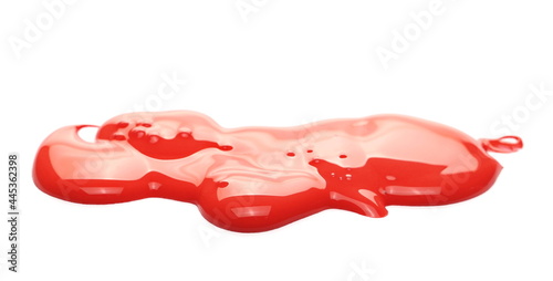 Spilled red paint puddle isolated on white background, side view
