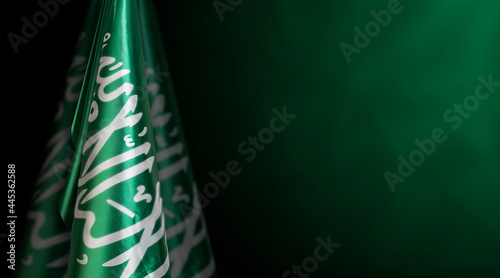 Saudi Arabia flags on left side with a dark green background, use it for national day and country national occasions