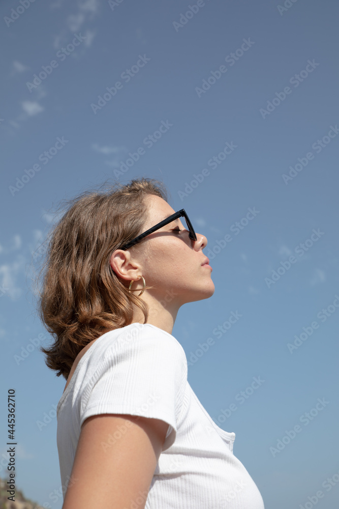 Natural beauty of as young lady in her vacation time enjoying her holidays in a beach of the coast side in a tourist location. breathing with a freedom feeling