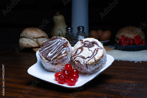 Freshly baked cakes served with red ripe cherries on the table photo