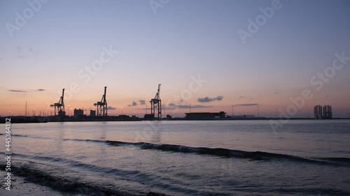 Time-lapse of the sunrise at cranes in the port