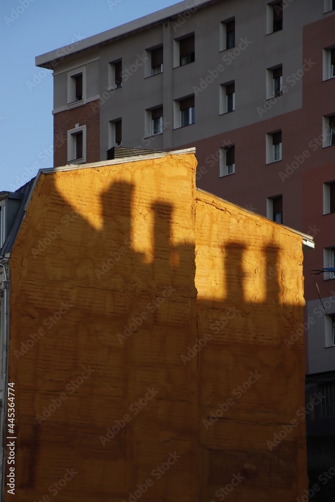 Shadow of chimneys on a facade